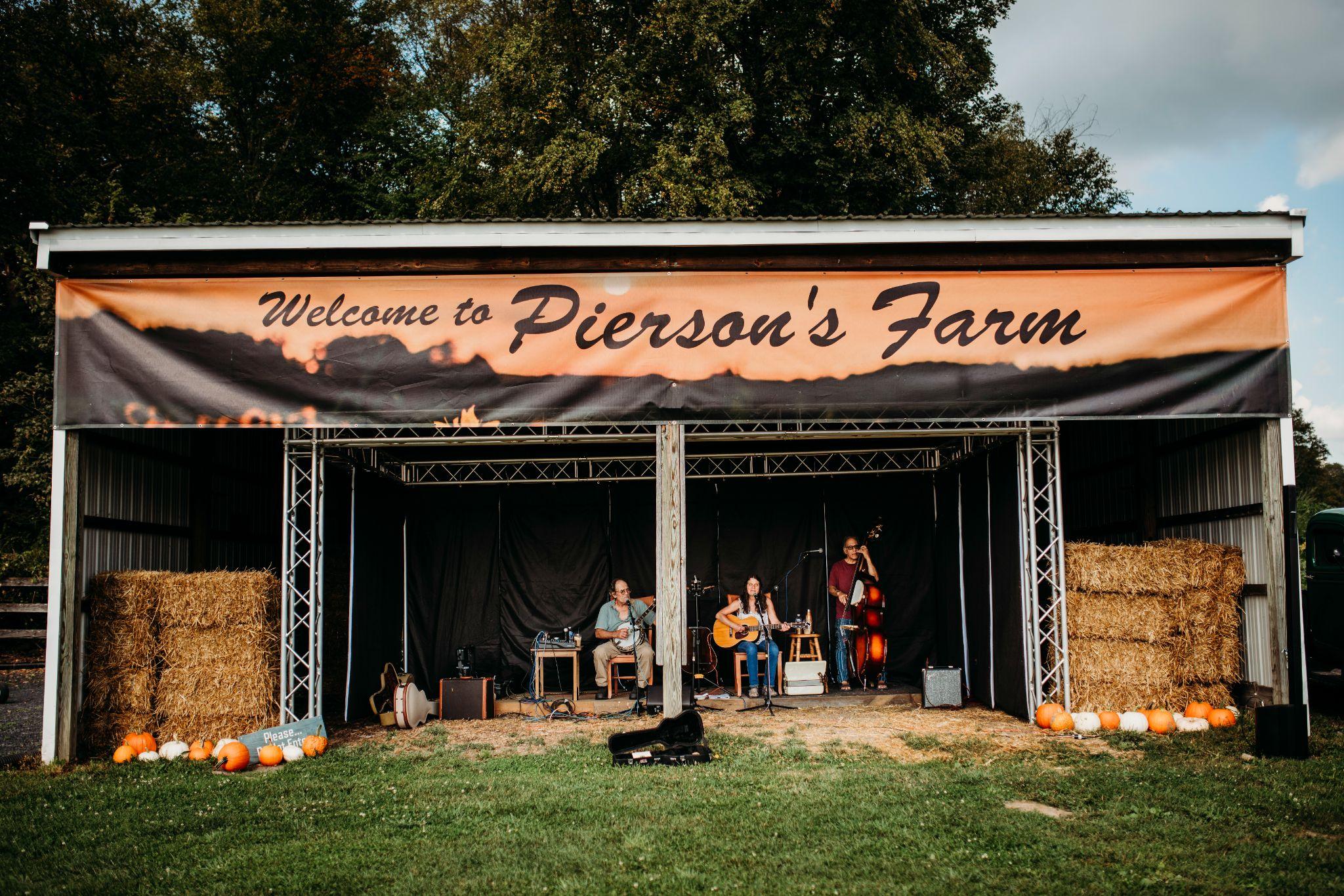 A band playing on the stage under the Welcome to Pierson's Farm banner
