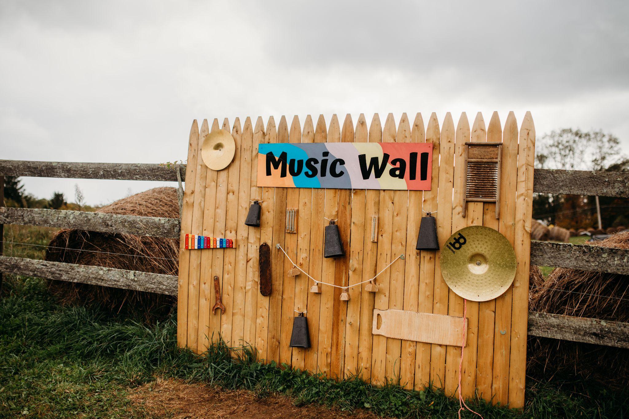 The music wall of bells, cymbals and chimes on a wooden fence